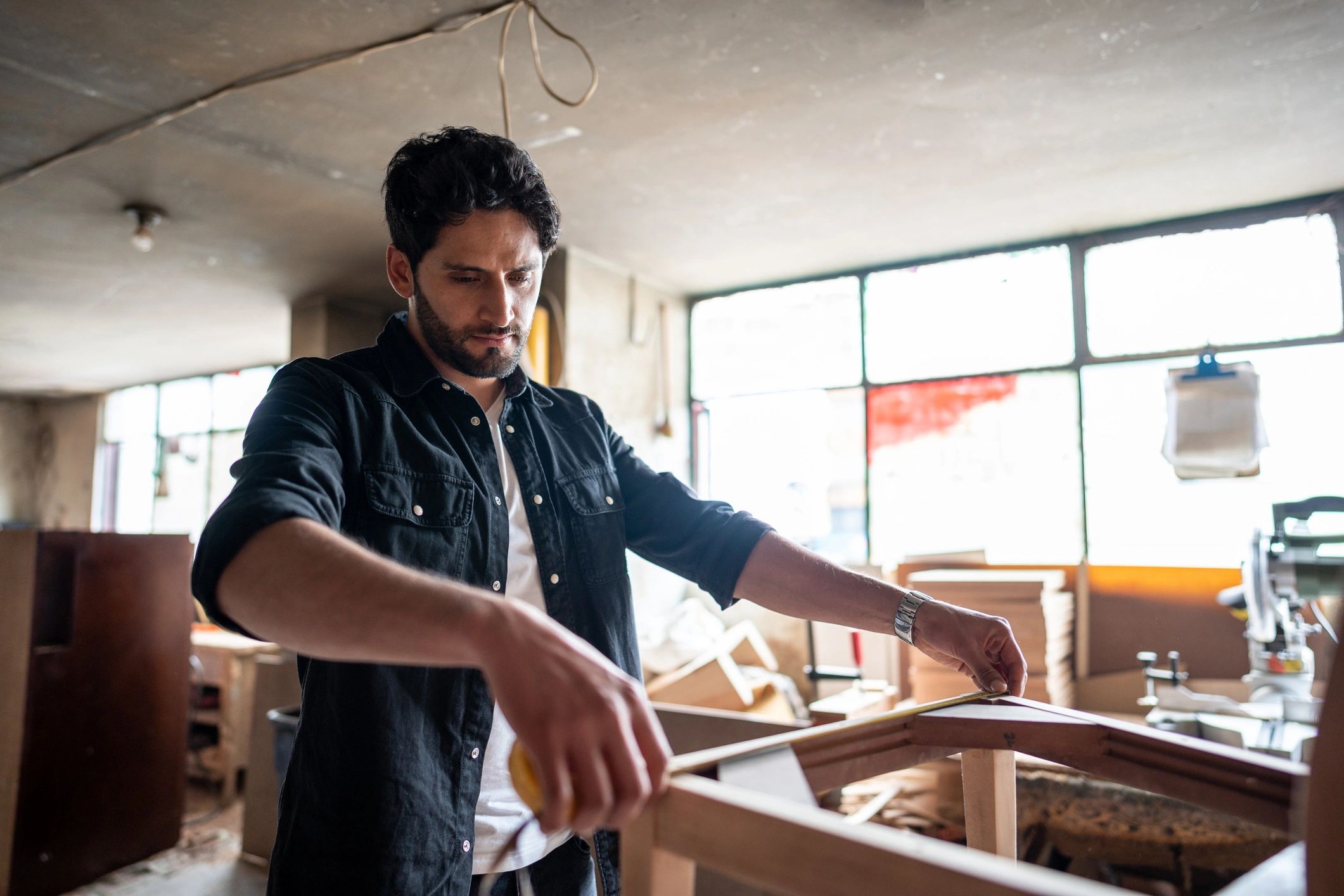 Tradesperson measuring with a tape measure
