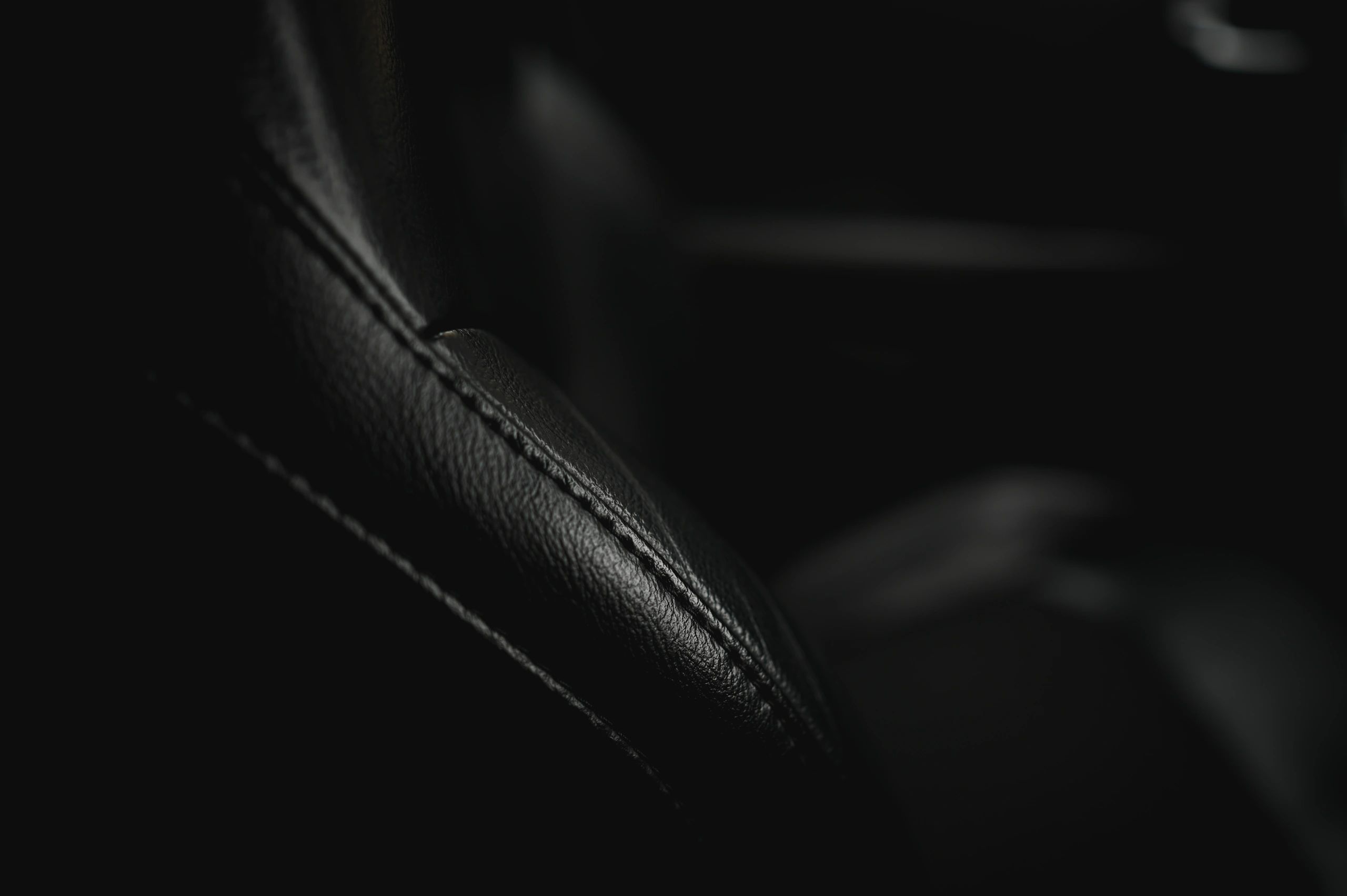 Close-up of leather car seat stitching