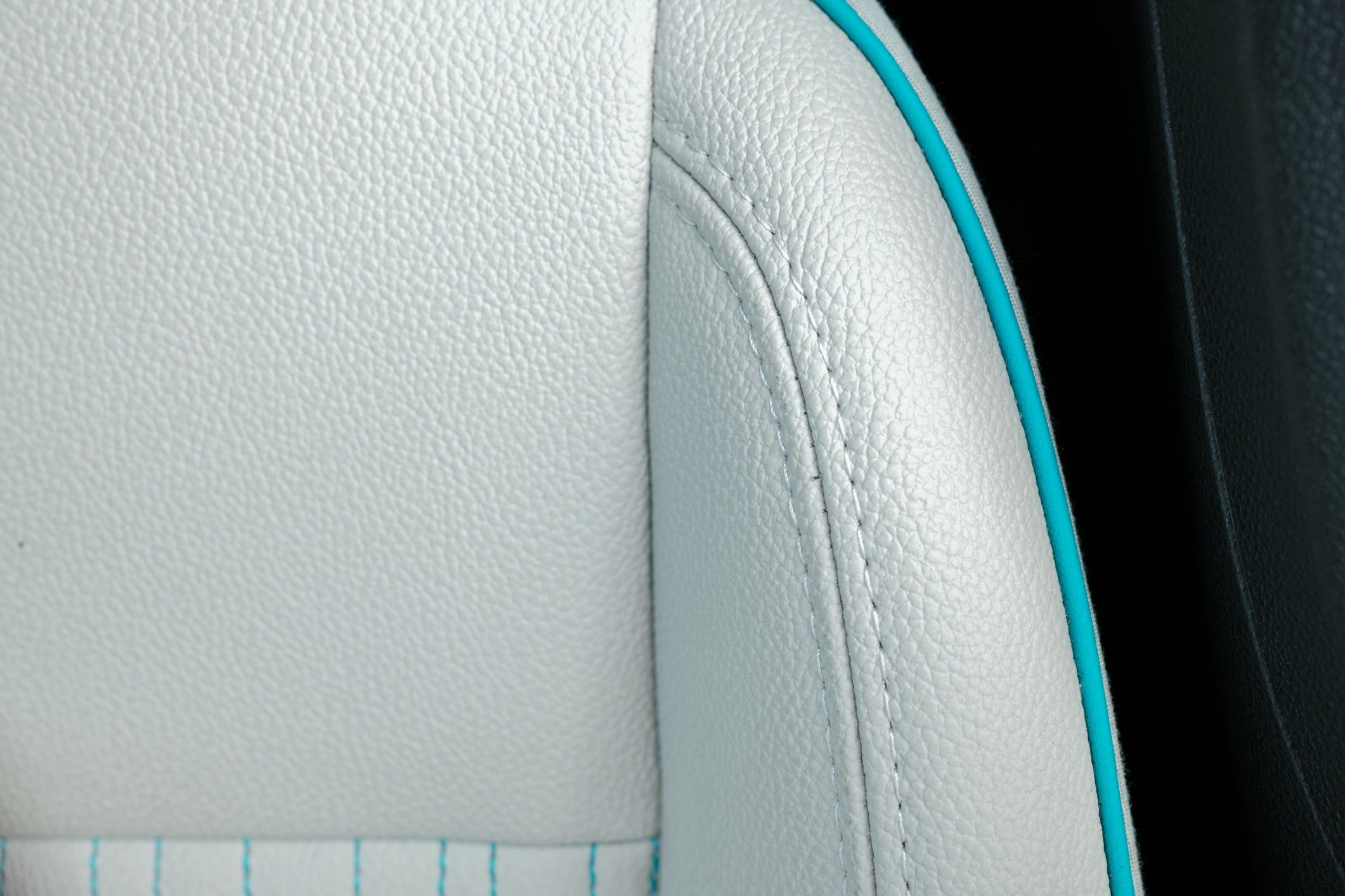 Close-up of vehicle seat upholstery stitching and trim detail